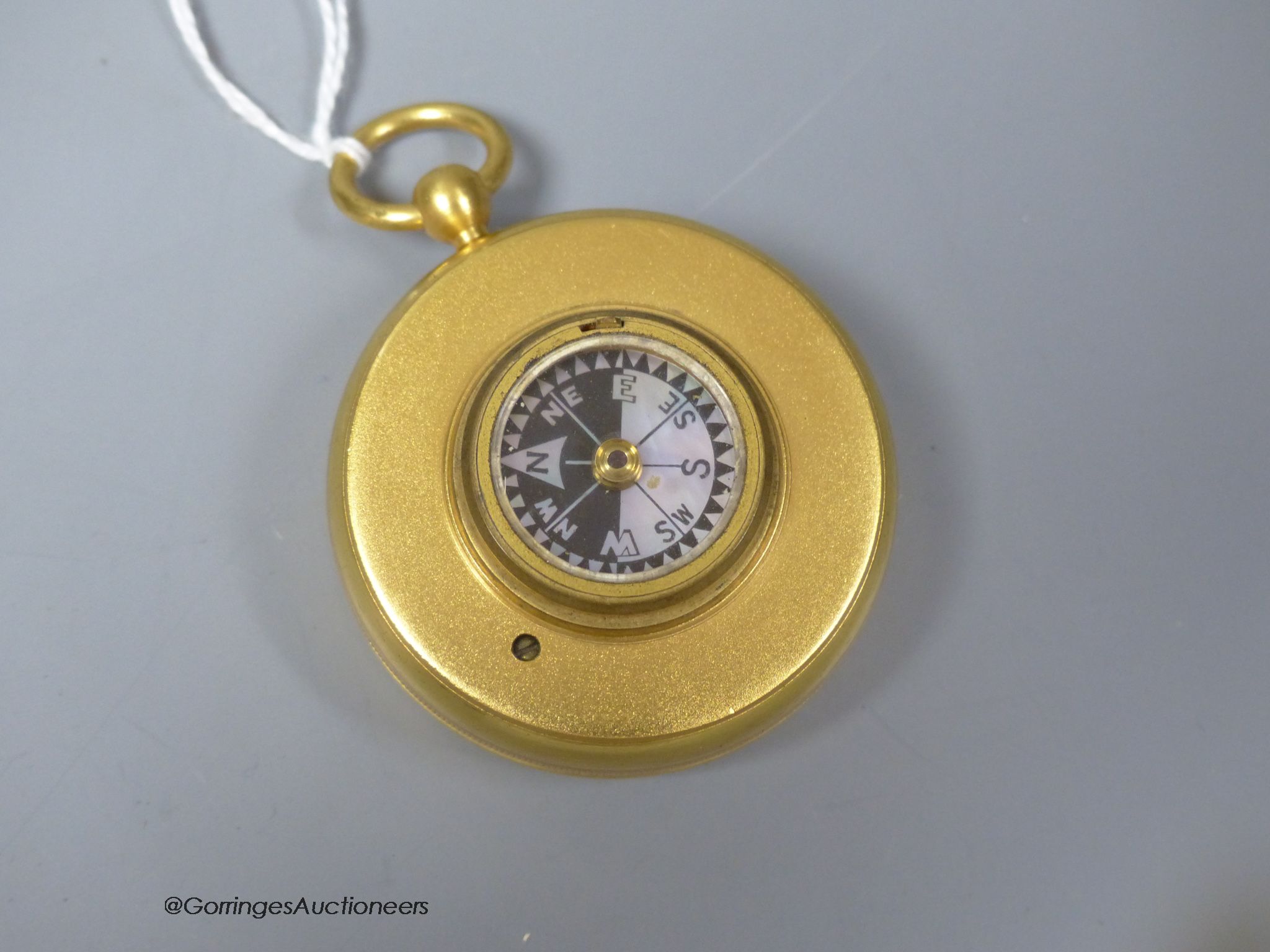 A 19th century gilt brass cased pocket barometer with compass, cased